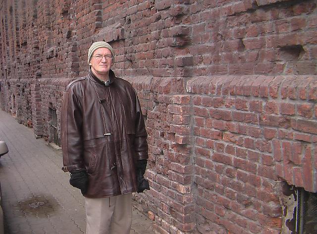 037.JPG - I am standing by a remnant of the Warsaw ghetto's wall.  You can see that it was quite tall and soundly built to try to prevent passage in and out.  The ghetto's inhabitants, however, found ways to get through it chiefly by sending out young children as smugglers.